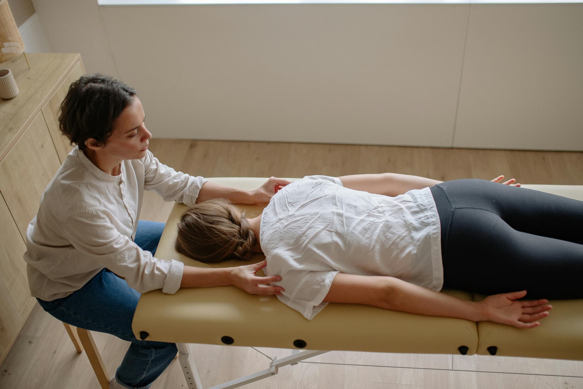 Modern chiropractic clinic with chiropractor treating patient